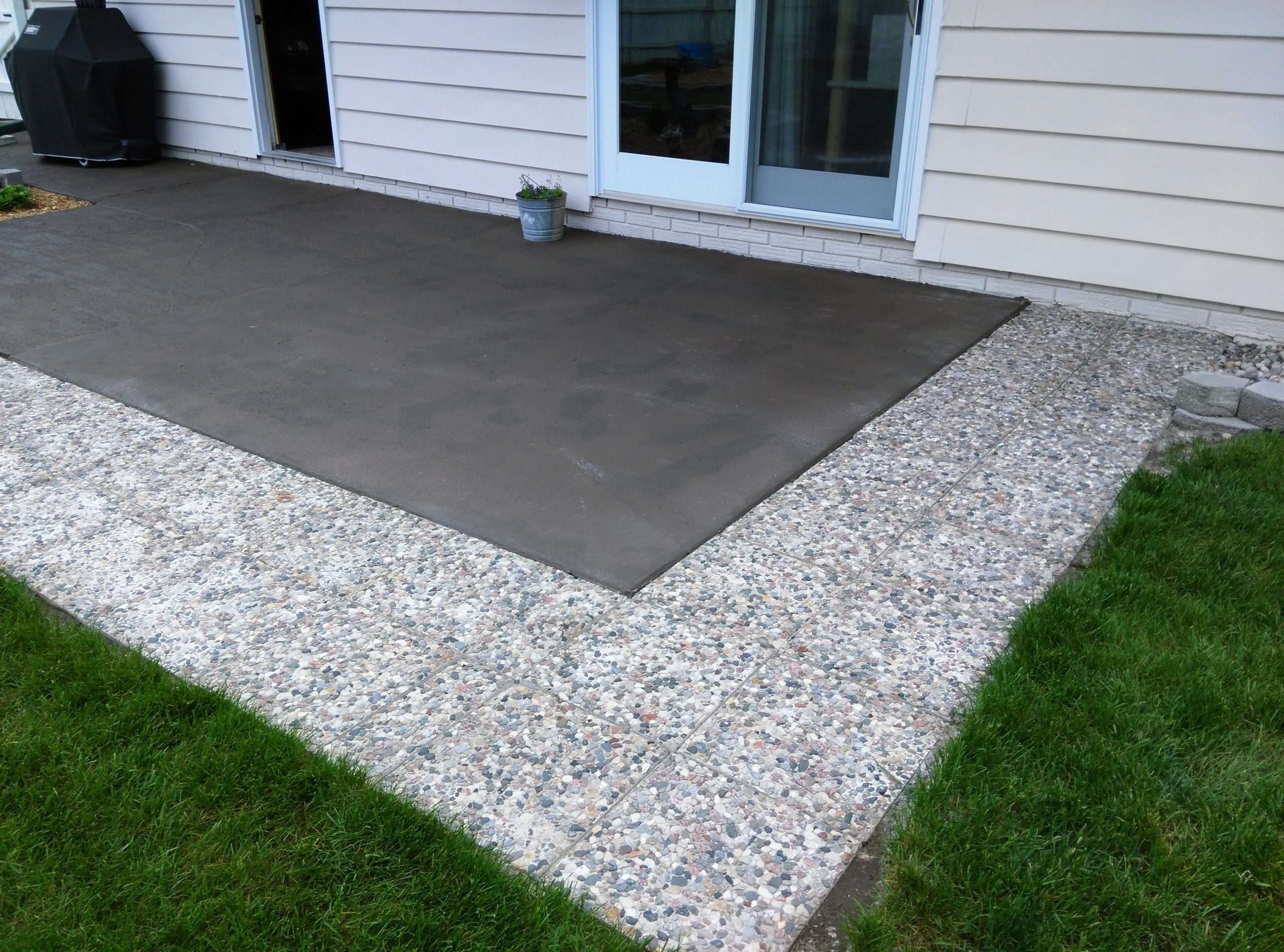 Had old slab cement patio painted bronze, added stone ...
