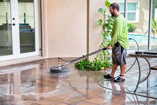 Power Washing Worker Cleaning Residential Pool Patio Tiles ...