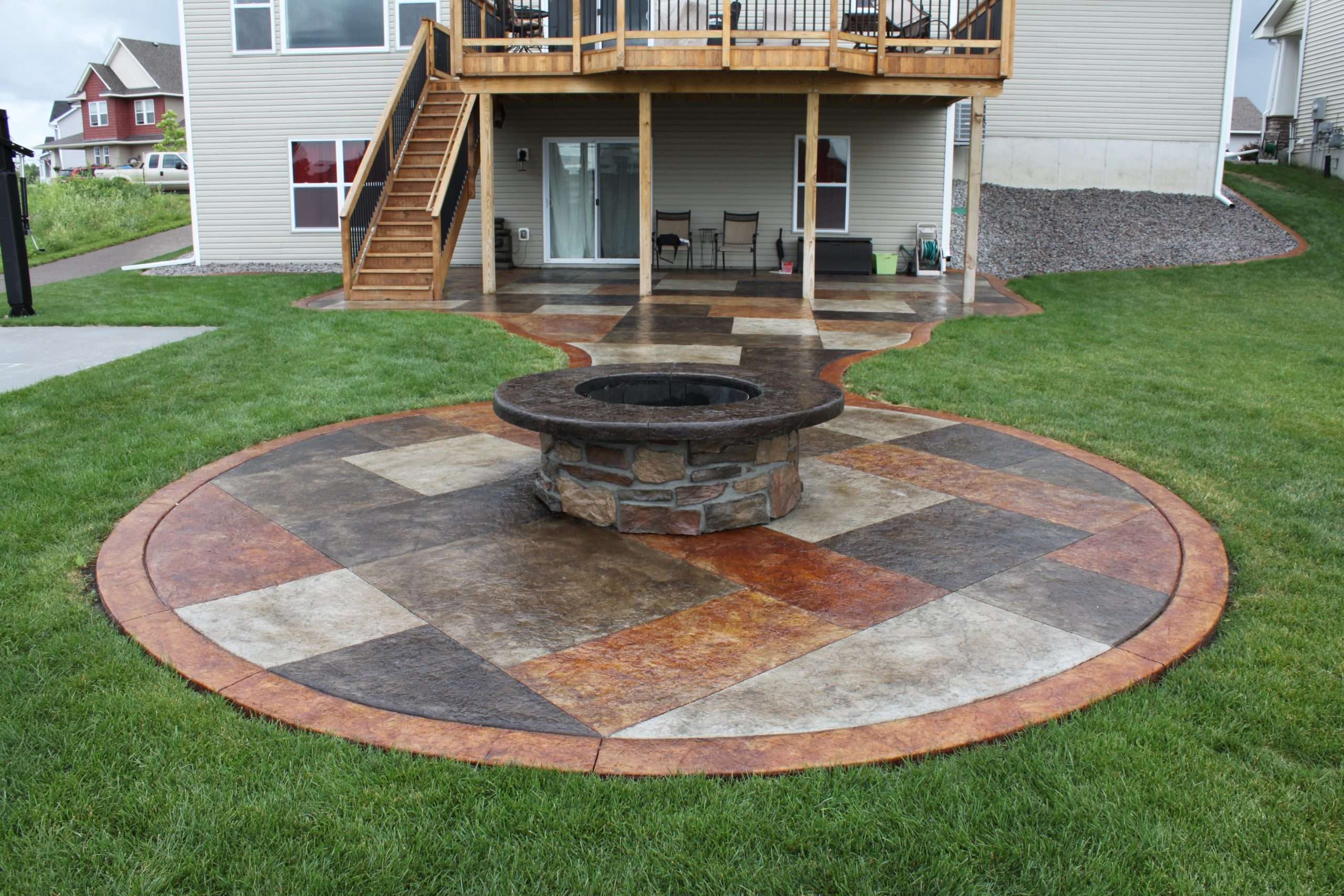 Stained concrete patio with a stone wrapped fire pit